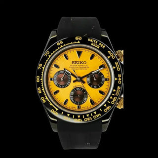 Seiko chronograph watch with a yellow dial, black bezel, and rubber strap.