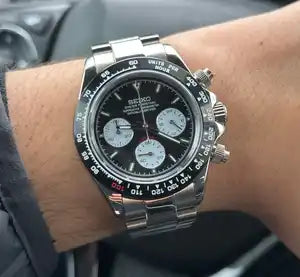 Stainless steel Rolex Daytona chronograph watch with a black bezel and three subdials.